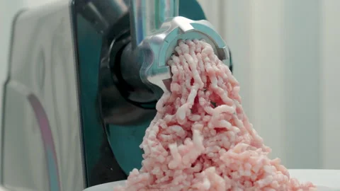 An electric meat grinder grinds pork. Stock Footage 319982457