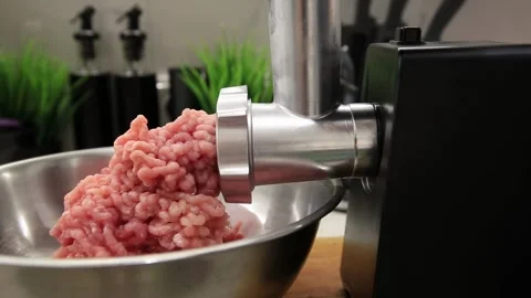 Electric meat grinder machine processing fresh raw meat into ground meat mixture Stock Footage 329621696