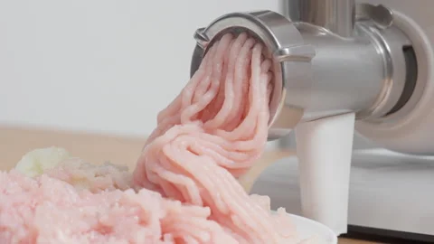 Electric meat grinder mincing fresh turkey meat with loud motor sound Stock Footage 329168150