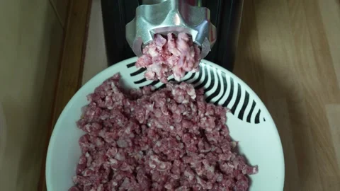 Electric Meat Grinder Mincing Raw Meat into Bowl 8K Close Up Stock Footage 333411665