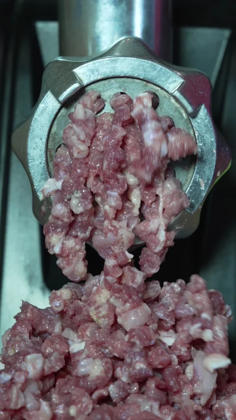 Electric Meat Grinder Mincing Raw Meat into Bowl 8K Close Up Stock Footage 333411670