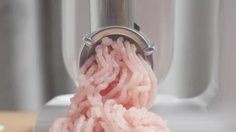 Electric meat grinder processing raw chicken meat with loud motor sound Stock Footage 329168004