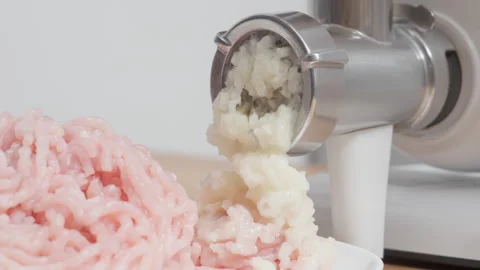 Electric meat grinder processing white onions with loud motor sound closeup Video stock 329168148