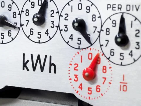Electric meter and dials close-up. KWH symbol. Stock Photos