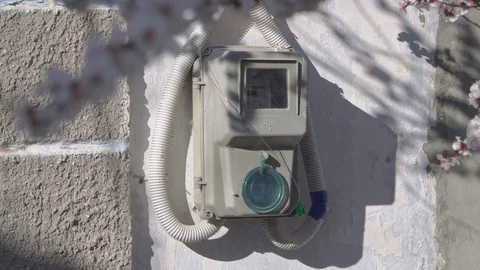 An electric meter hangs on the outside wall of the house сlose-up Stock Footage 105532255