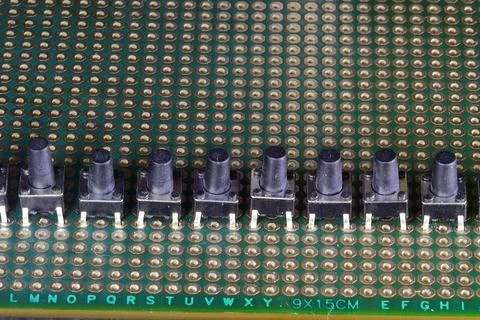 Electric micro buttons installed in the display row on the circuit board Stock Photos
