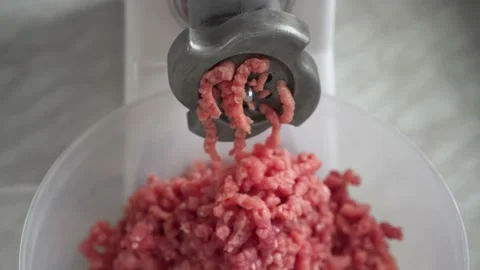 Electric mincer machine closeup. Grinder with fresh chopped meat. Stock Footage 135082300