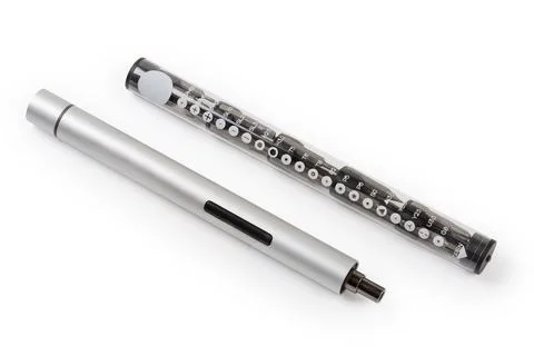 Electric mini screwdriver and set of interchangeable bits in case Stockfoto's