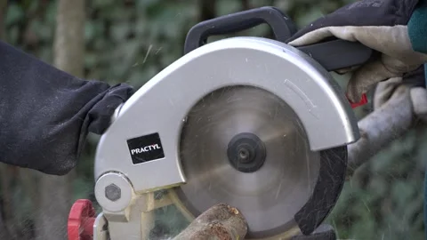 Electric miter saw Practyl on workbench.  Close-up. Gardener cuts small logs . Stock Footage 166506678