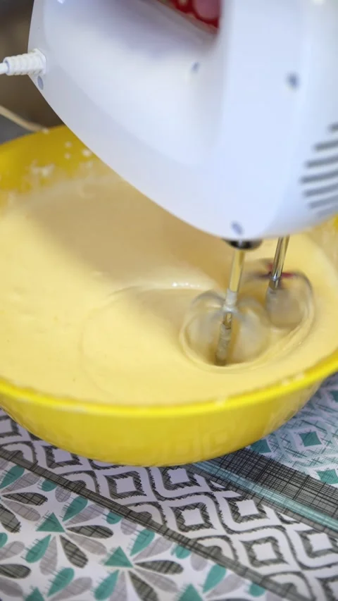 Electric Mixer Beating Yellow Batter in Bright Yellow Bowl1 Vídeo Stock 333010286