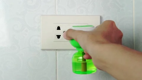 Electric mosquito trap device. Plugging the electric mosquito repellent into a p Stock Footage 169165294