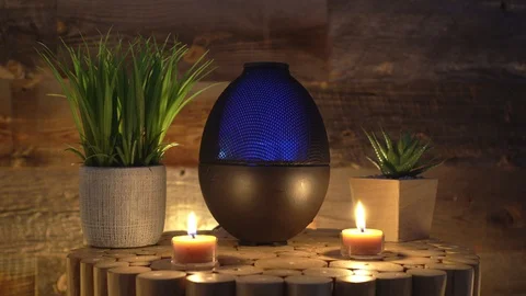 Electric oil diffuser lamp candles on wooden table in room, Aromatherapy Video stock 129296110