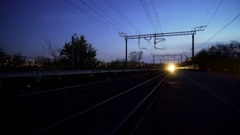 Electric old passenger train is stopping on station at night.	 Stock Footage 129074729