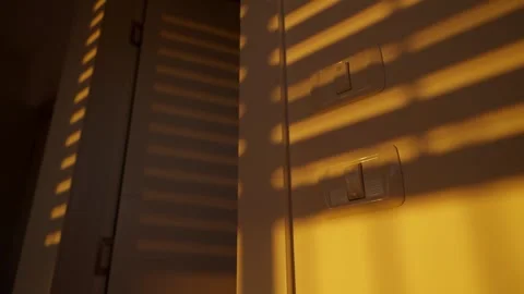 Electric or mechanical window blinds or shutter roll down at sunset or sunrise Stock Footage 309842951