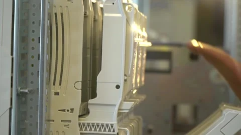 Electric panel, electrician is pulling big levers to install fuses, factory Stock Footage 160113631