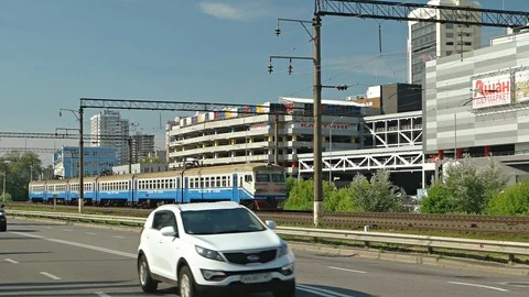 Electric passenger train passes alongside Mykoly Hrinchenka Street in Kiev Stockbeeldmateriaal 74624936