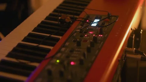 An electric piano keyboard and knobs live on stage at a concert 動画素材 109260598