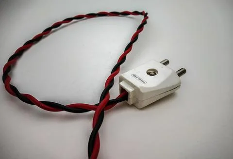 Electric plug close up shot with red wire in a white background 스톡 사진