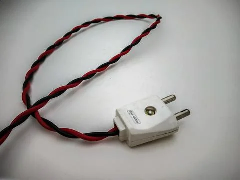 Electric plug close up shot with red wire in a white background Stock-Fotos
