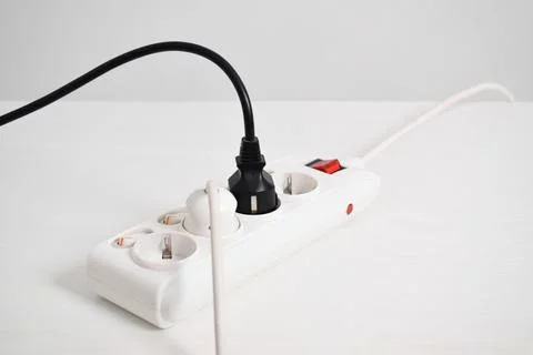Electric plug, Multiple socket with connected plugs. Electrical plug in outle Stock Photos