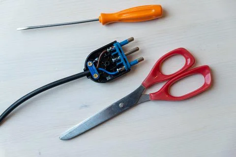 Electric plug, screwdriver and scissors Stock Photos