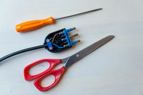 Electric plug, screwdriver and scissors Stock Photos