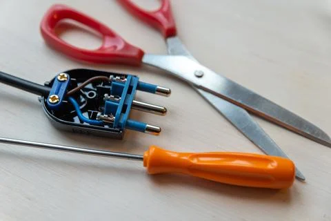 Electric plug, screwdriver and scissors Stock Photos