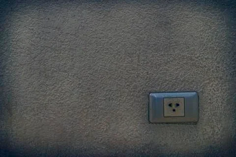 Electric plug socket built in old wall. Stock Photos