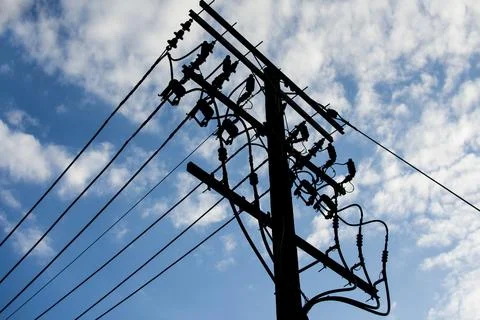Electric pole connect to the high voltage electric wires with blue sky back.. Stock Photos
