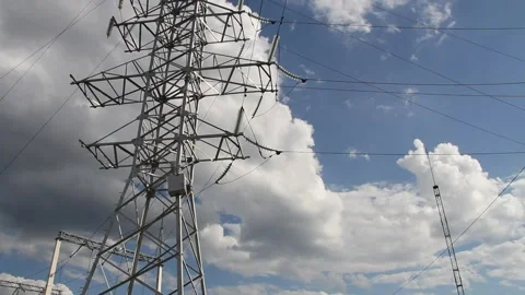 Electric pole with high voltage wires close up against a blue sky Stock Footage 137250448
