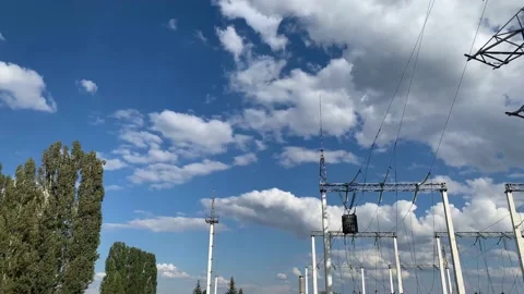Electric pole with high voltage wires close up against a blue sky Video stock 139997754