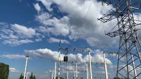 Electric pole with high voltage wires close up against a blue sky Stock Footage 139997764