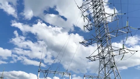Electric pole with high voltage wires close up against a blue sky Stock Footage 139997774