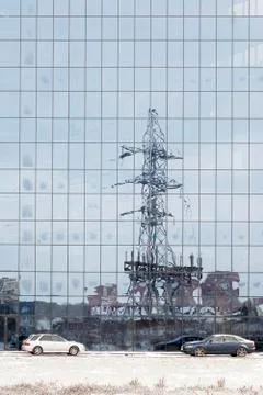 Electric pole reflected in windows of office building Stock Photos