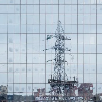 Electric pole reflected in windows of office building Stock Photos
