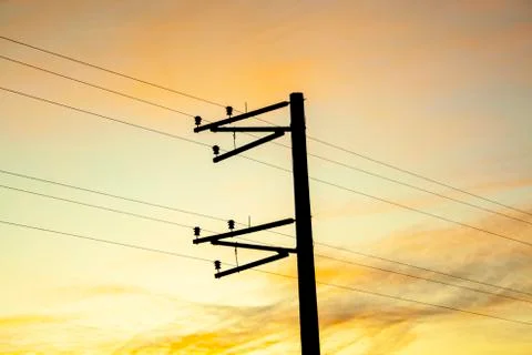 Electric pole shape against the sunset Stock Photos
