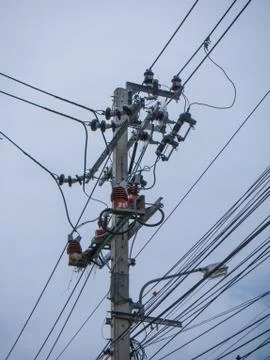 Electric pole,cables and blue sky background Stock Photos