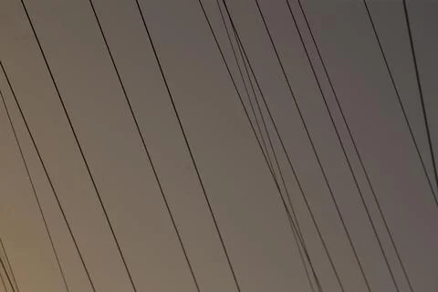 Electric poles create harmonious visual rhythm against evening sky Stock Photos