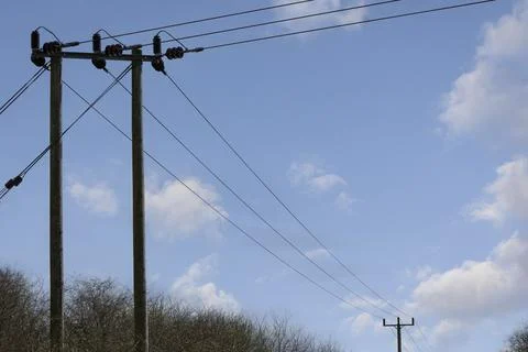An electric post with a cloudy sky background Stock Photos