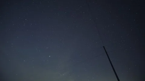 Electric Power Line Poll Time Lapse Star Tracking Rotation Northern Sky at Night Video stock 106857143