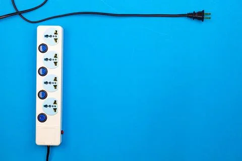 Electric power socket and plug on blue paper background Stock Photos