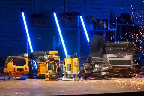 Electric power tools are on the workbench in the workshop: a jigsaw, a drill, a Stock Photos