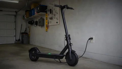 Electric scooter being charged Stock Footage 345983278
