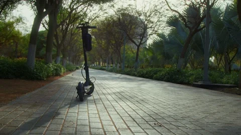 Electric scooter standing in a park Stock Footage 299753602