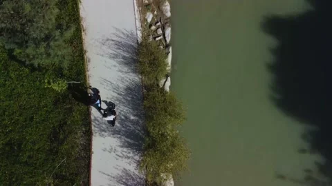 Electric scooters. Drone aerial sequence shot. Follow-up of a couple of boy a Stock Footage 220879890