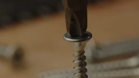 Electric screw driver drilling out screw and falling in slow motion. Loose Stock Footage 261130020