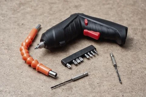Electric screwdriver with drill bits, and an orange flexible extension on a.. Stock Photos