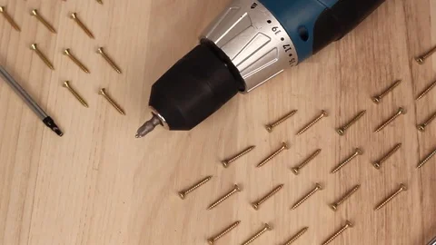 Electric screwdriver in hand at white desk background Stock Footage 75149960