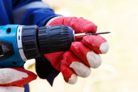 Electric screwdriver in the hands of a carpenter Stock Photos