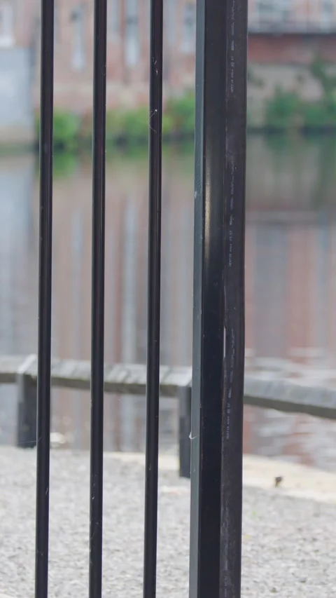 Electric Security Gate Closing Beside Urban Waterfront Wall Stock Footage 316009155